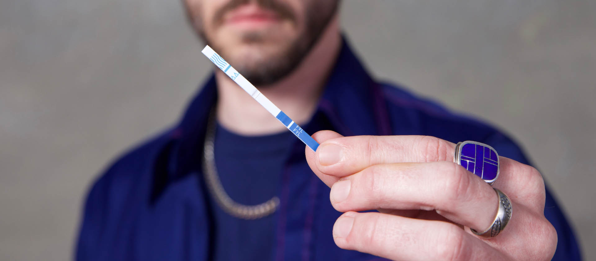 Person holding a drug testing strip.